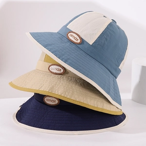 Close-up of three color-block nylon kids sun hats with aimax woven label patches