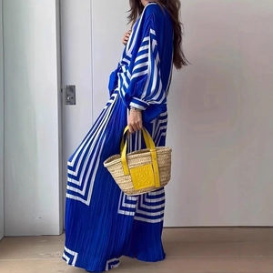 Detailed view of the pleated texture and blue striped pattern on these relaxed pants