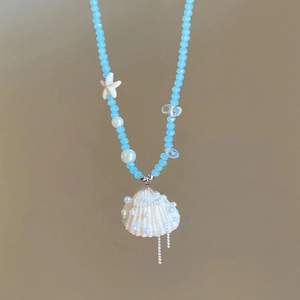 Detail of blue beaded ocean necklace with shell pendant and 84cm plus 7cm length guide