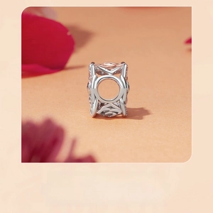 Macro shot of silver charm with hollow rose pattern and elegant rose gold plating detail