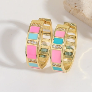 Detail of gold geometric hoop earrings with pink blue enamel and white zircon stones