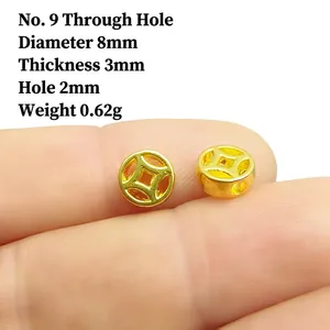 Macro view of 8mm gold coin spacer beads for jewelry making showing size and detail