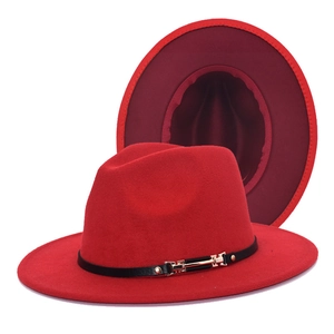 Detailed view of red wool fedora featuring black leather band with golden metal buckle