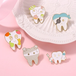Detailed view of five creative cartoon tooth enamel pins for dental health awareness.
