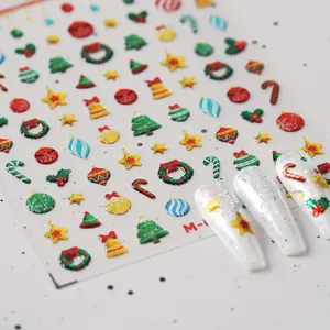Detailed macro view of 3D embossed Christmas nail art stickers with festive tree patterns