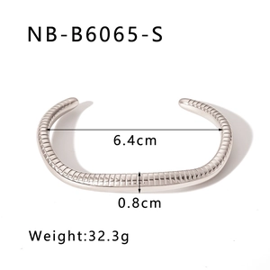 Detail view of silver stainless steel cuff showing 0.8cm width and 6.4cm diameter