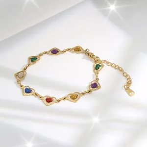 Detail of a gold heart link bracelet with colorful glitter charms and adjustable clasp