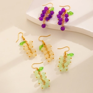 Detail of colorful grape drop earrings in purple and green with transparent leaves