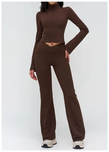 Detail of cross V-waistband and side pockets on brown flared yoga pants set