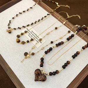18K gold plated tiger eye necklaces set with leopard heart pendants on white display