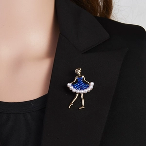 Close-up of ballet dancer brooch with blue rhinestones and pearls on black blazer