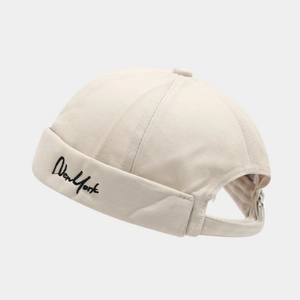 Close-up of New York embroidery and adjustable back strap on beige docker hat