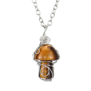 Detail of handcrafted wire-wrapped tiger eye stone mushroom pendant with silver chain