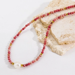 Faceted rhodochrosite and baroque pearl handmade necklace with gold beads on stone