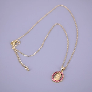 Detail of a gold Virgin Mary oval pendant necklace with a circle of pink zircon stones