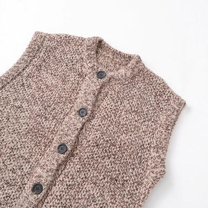 Fashionable brown chunky knit vest for women with classic buttons on white background