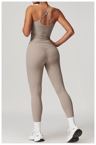 Detail of cross back yoga vest and high-waisted leggings in earthy taupe matte fabric
