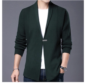 Detailed close-up of dark green knitted cardigan blazer featuring a fine metal buckle clasp