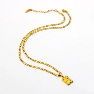 Detail of 18K gold Figaro chain necklace with a textured rectangular checkered pendant