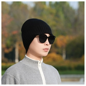 Close-up of black ribbed knit beanie showing thick texture and warm fleece lining