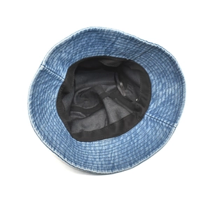 Internal view of blue denim bucket hat showing the black fabric lining and fine stitching
