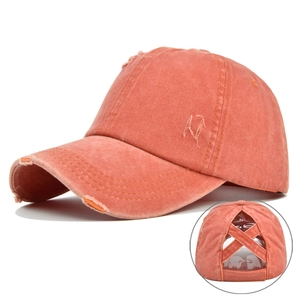 Detail of vintage washed ponytail baseball cap with criss-cross elastic back design