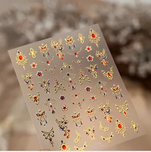 Detailed view of red and gold Chinese style nail art stickers with phoenix pattern