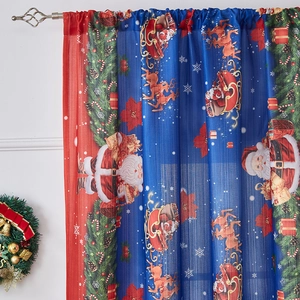 Detail of Christmas themed dark blue curtains with Santa, reindeer and snowflake patterns