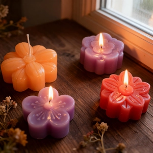 Detailed view of colorful flower-shaped candles with realistic petal textures and flames