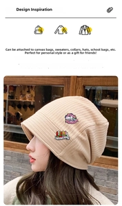 Detail of literary enamel pins featuring book and flower designs on a knitted hat