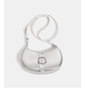 Detail of silver metallic crescent shoulder bag showing adjustable strap and buckle