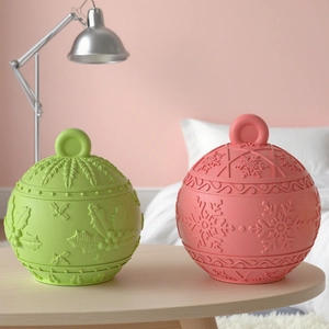 Green and pink festive bauble jars with holly leaf and snowflake embossed patterns