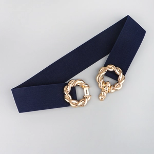 Detail of navy elastic belt featuring a golden interlocking twisted metal buckle