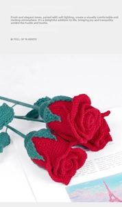 Close-up of handmade crochet red roses with intricate knit patterns and green stems