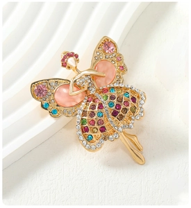 Macro detail of ballerina brooch with colorful rhinestones and opal stone settings