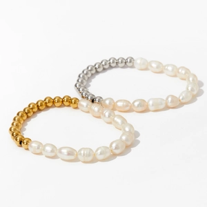 Detail of freshwater pearl bracelets with gold and silver beads on white background