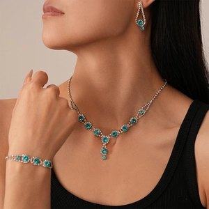 Detailed view of luxury vintage blue crystal necklace earrings and bracelet set on a model