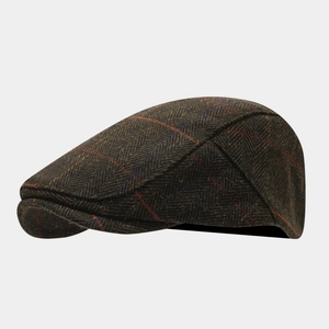 Side view of wool blend plaid newsboy cap showing detailed brown herringbone texture