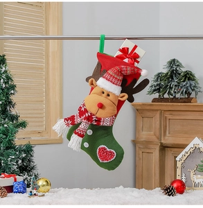 Close-up of knit Christmas stocking featuring a 3D reindeer doll and hanging loop