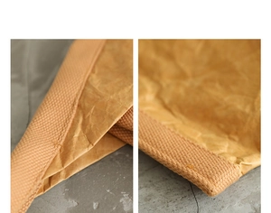 Macro detail of brown crinkled DuPont paper material with woven fabric edge stitching