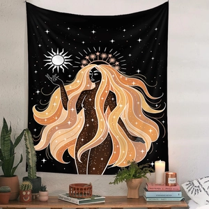 Detail of bohemian black sun goddess tapestry showing golden hair and star patterns