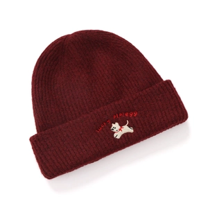 Close-up of burgundy ribbed knit beanie featuring white puppy and letter embroidery detail