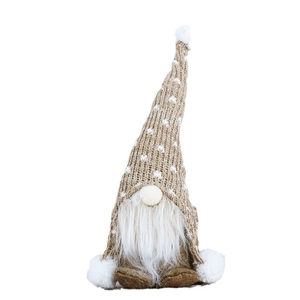 Nordic Christmas gnome with knitted snowflake hat and white beard in a sitting pose