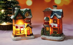 Detail view of glowing Christmas resin houses with snowy ice cream and gift shop designs