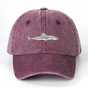 Close-up of the detailed grey shark embroidery on the burgundy washed cotton baseball cap