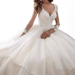 Elegant white ball gown wedding dress with deep V-neck, lace embroidery, and sheer long sleeves