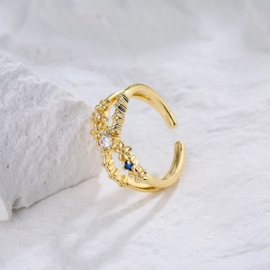 Double layered gold plated ring with marquise zircon stones and a blue accent gem