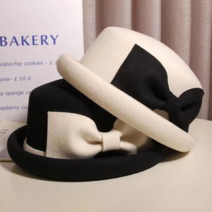 Detail of wool cloche hats with contrasting large bows in black and white styles