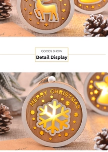 Detail of wooden Christmas ornaments with hollow reindeer and angel patterns and LED light