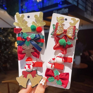 Christmas hair clip set featuring golden antlers, plush balls and festive bows for girls